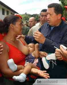 Venezuelan President Hugo Chavez talks with people who were affected by flooding in Araira in Miranda state, about 50 km (31 miles) from Caracas, Venezuela, Saturday, Feb. 12, 2005, after floodwaters receded following a disaster that has left at least 15 people dead. (AP Photo/Miraflores, Marcelo Garcia)